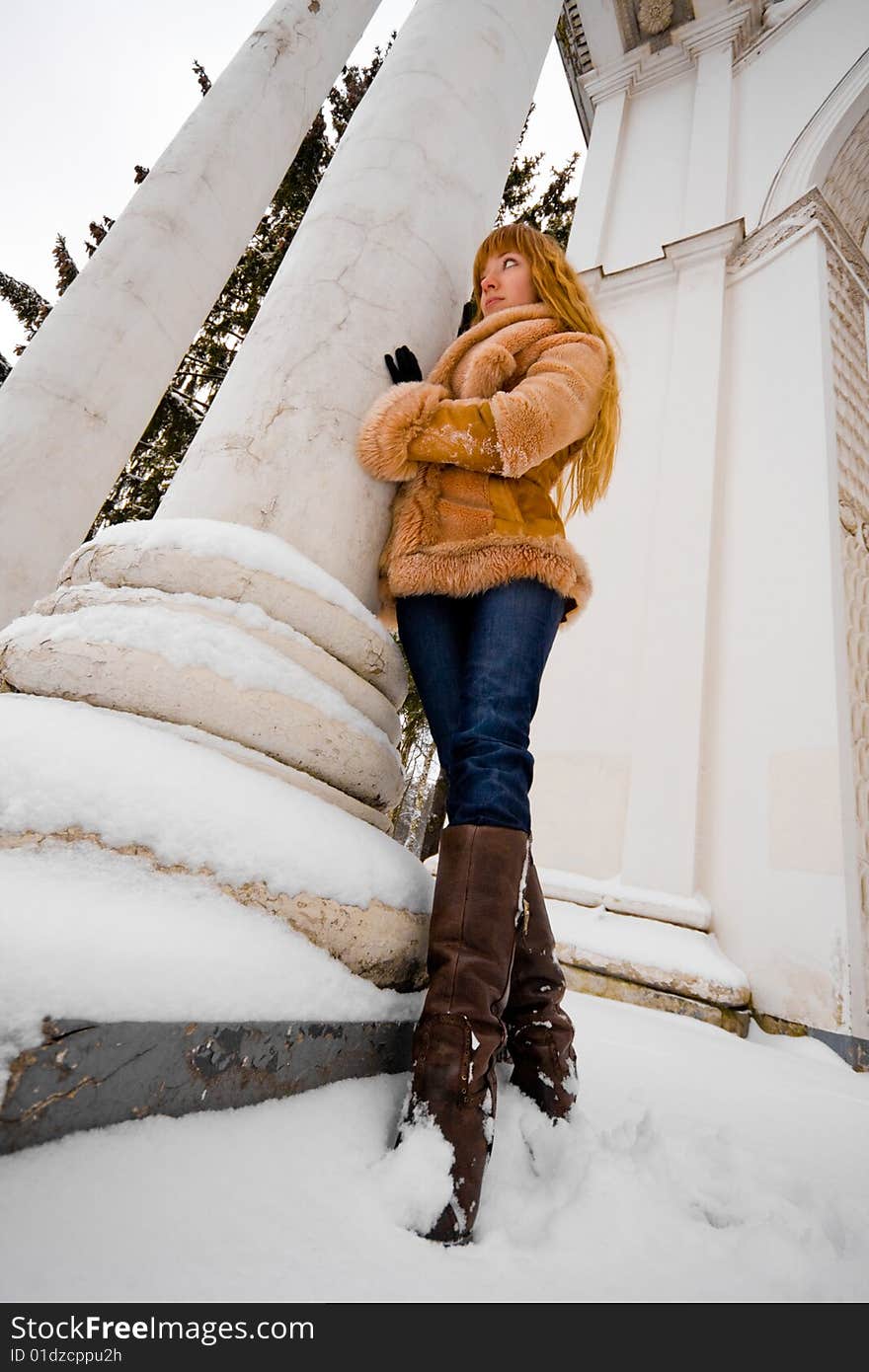 Red-heared girl in short fur coat outdoors - wide angle portrait. Red-heared girl in short fur coat outdoors - wide angle portrait