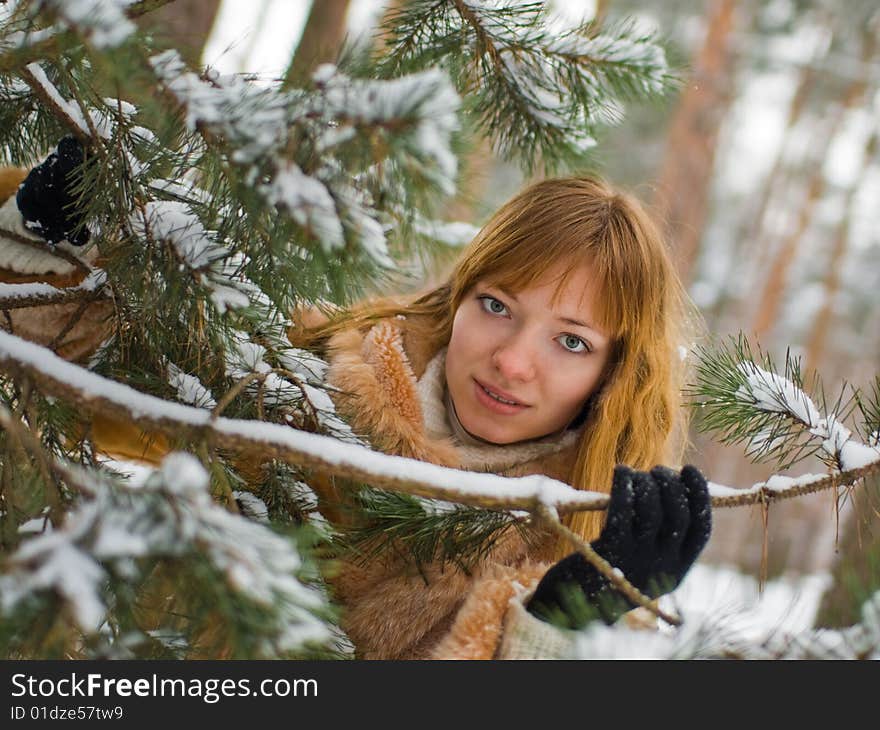 Red-heared girl in fur coat outdoors - shallow DOF. Red-heared girl in fur coat outdoors - shallow DOF