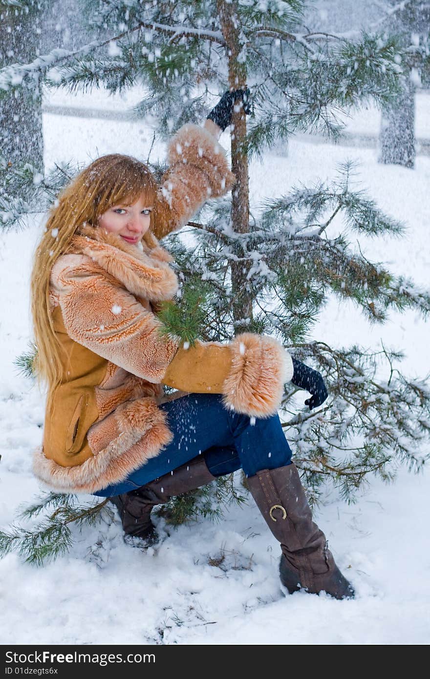 Red-heared girl in short fur coat outdoors - shallow DOF. Red-heared girl in short fur coat outdoors - shallow DOF