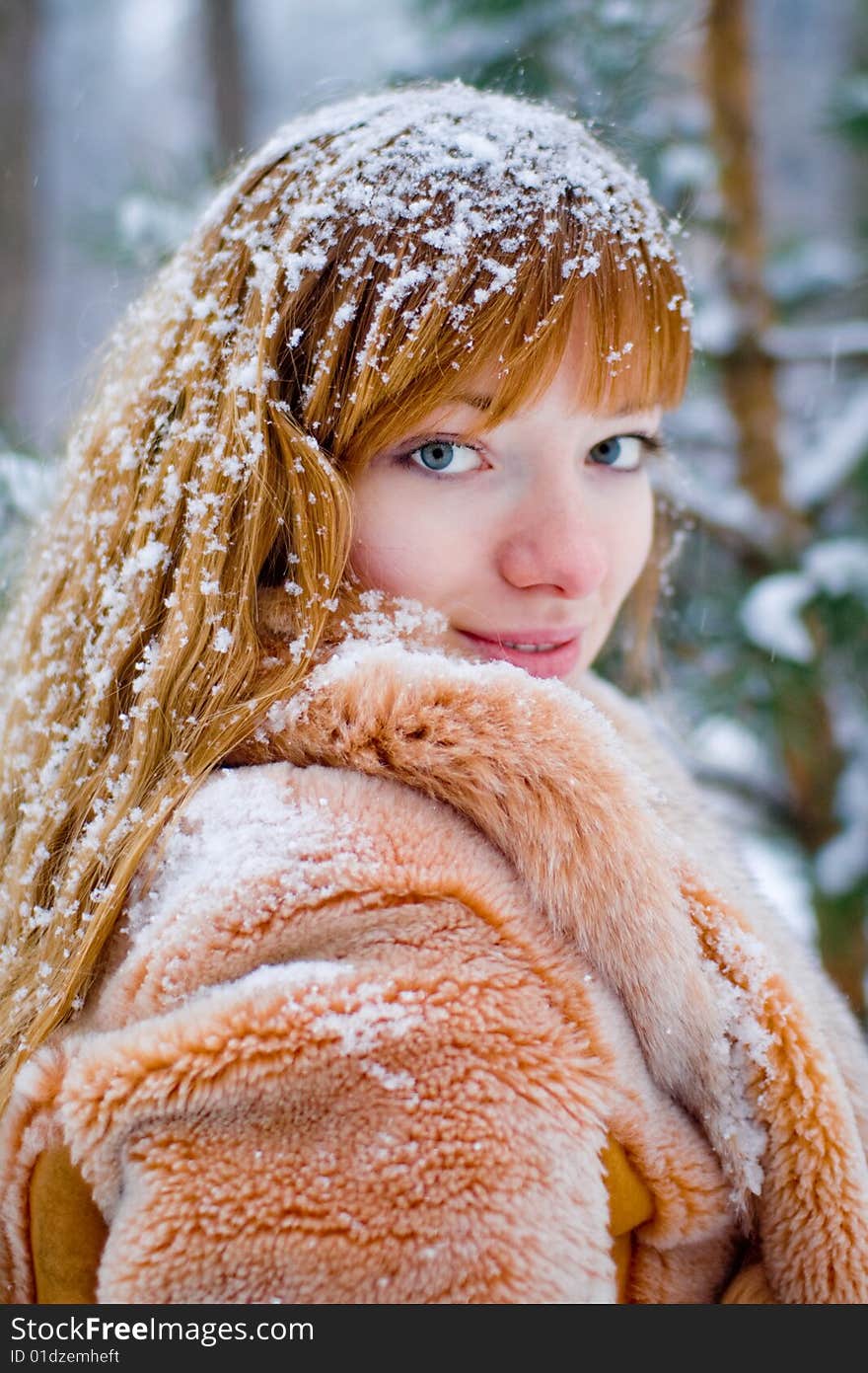 Red-heared girl in fur coat outdoors - shallow DOF. Red-heared girl in fur coat outdoors - shallow DOF