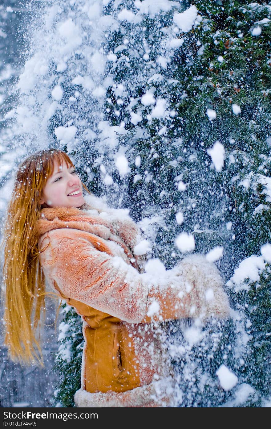 Red-heared girl in fur coat outdoors - shallow DOF. Red-heared girl in fur coat outdoors - shallow DOF