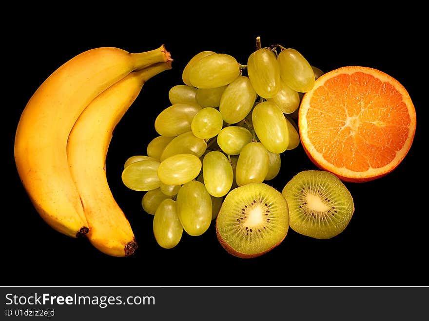 Kiwi, grapes, banana, background black. Kiwi, grapes, banana, background black