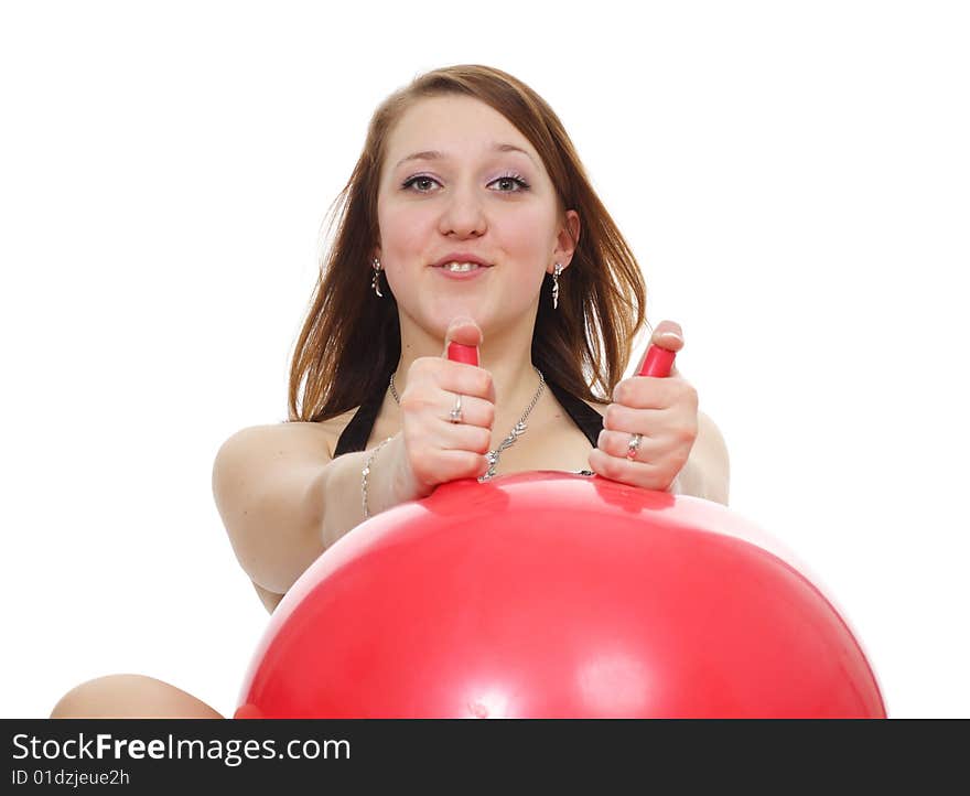 The girl has a good time with a red sphere is isolated on a white background. The girl has a good time with a red sphere is isolated on a white background