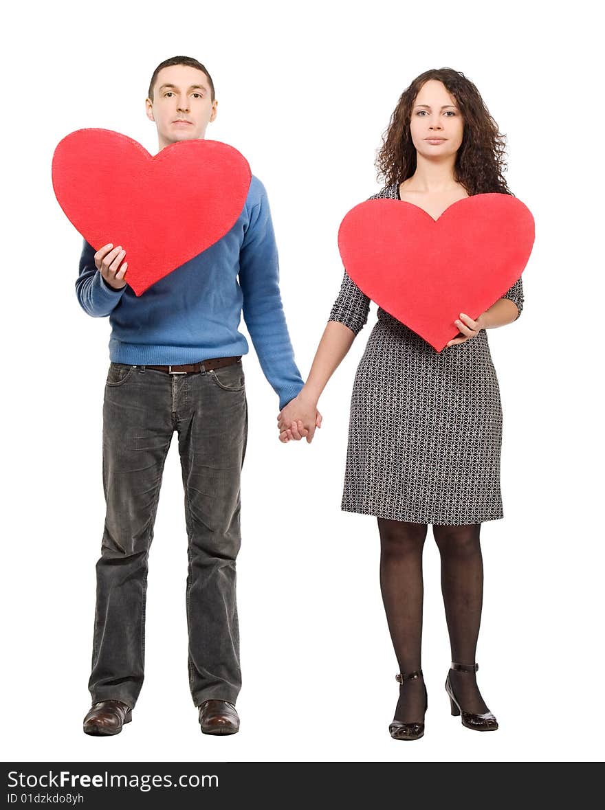 Couple holding two red hearts  isolated over white