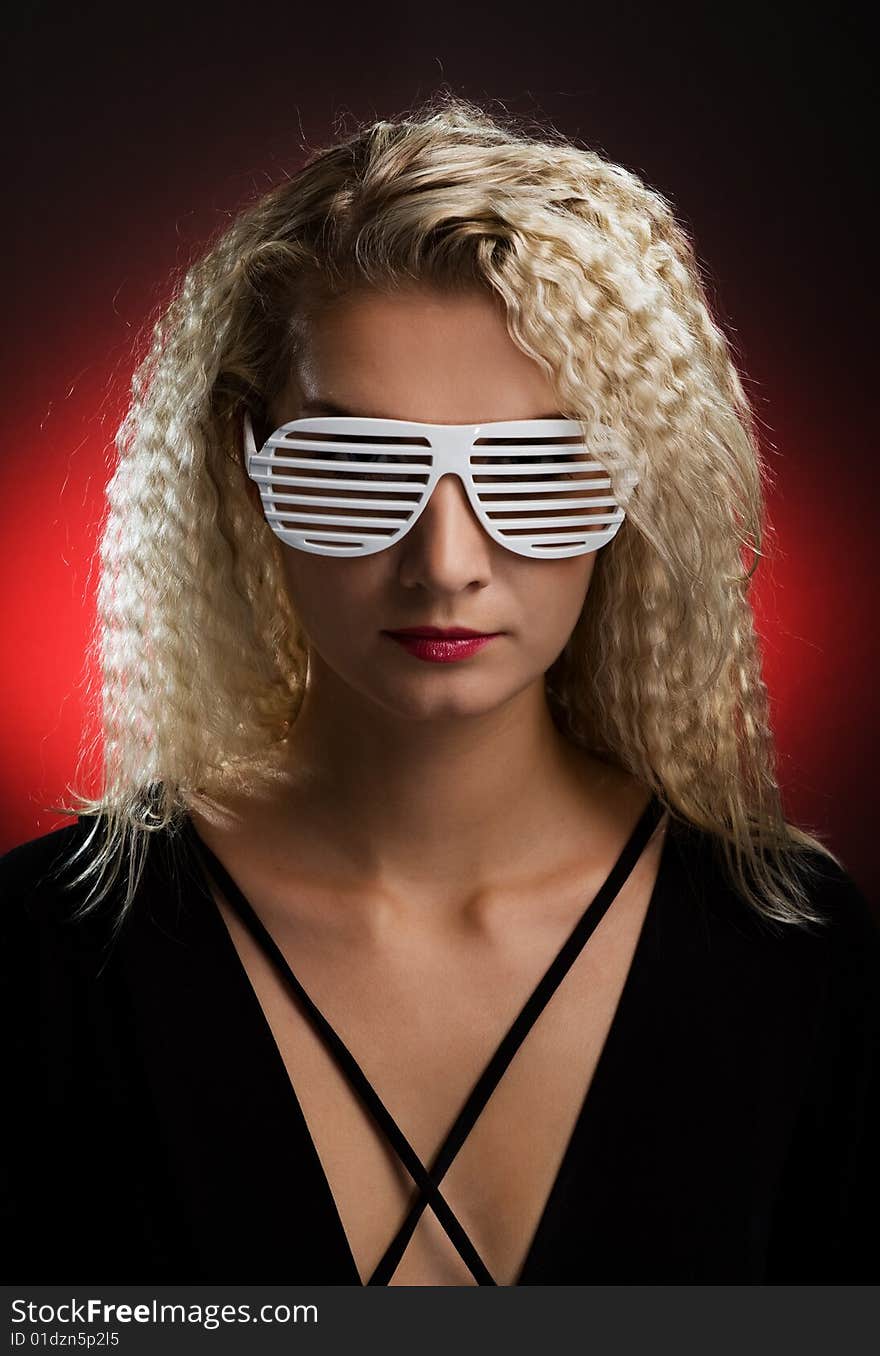 Beautiful blond woman with stylish shutter shades sunglasses