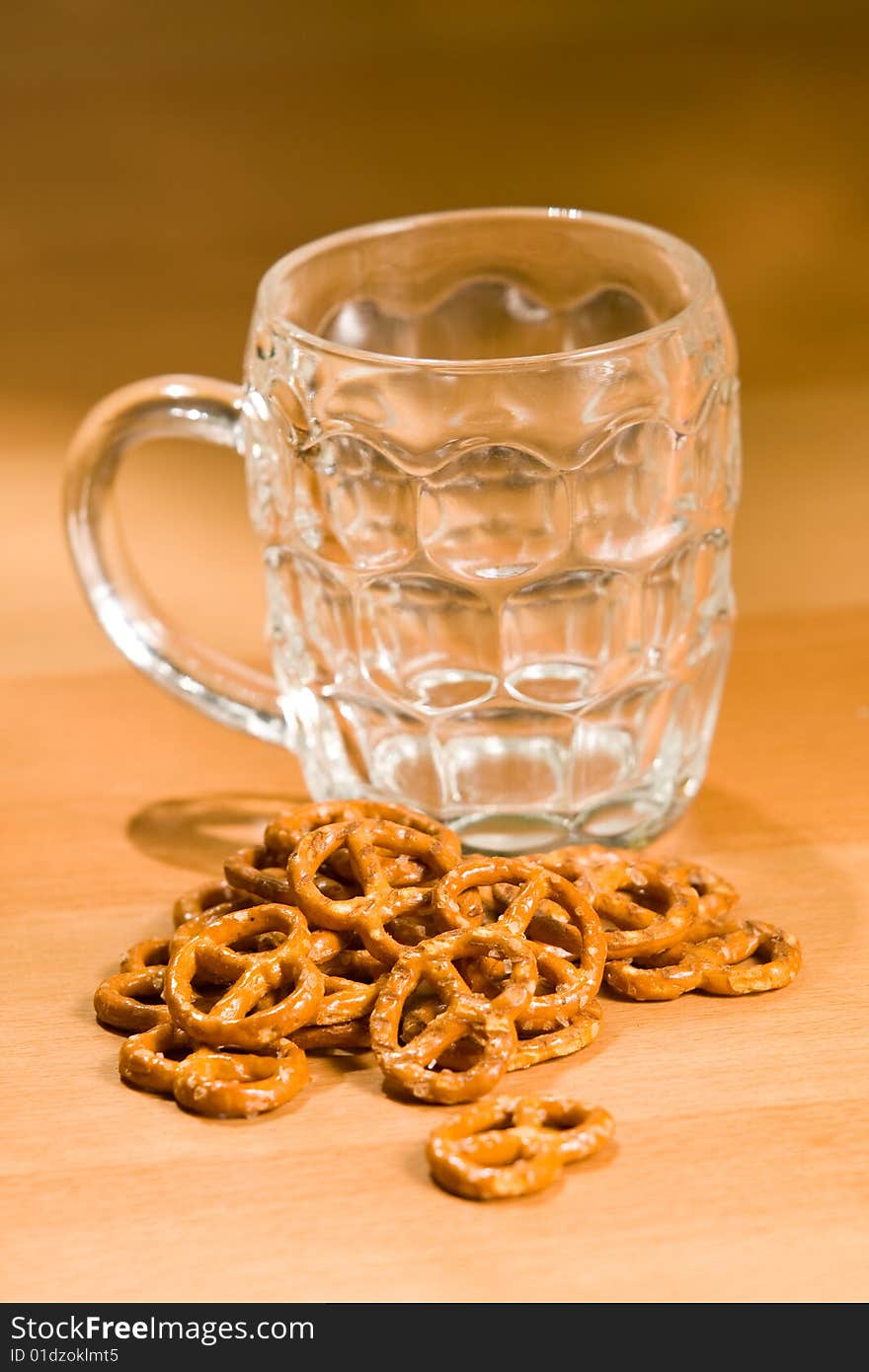 Empty beer glass with salty snacks. Empty beer glass with salty snacks