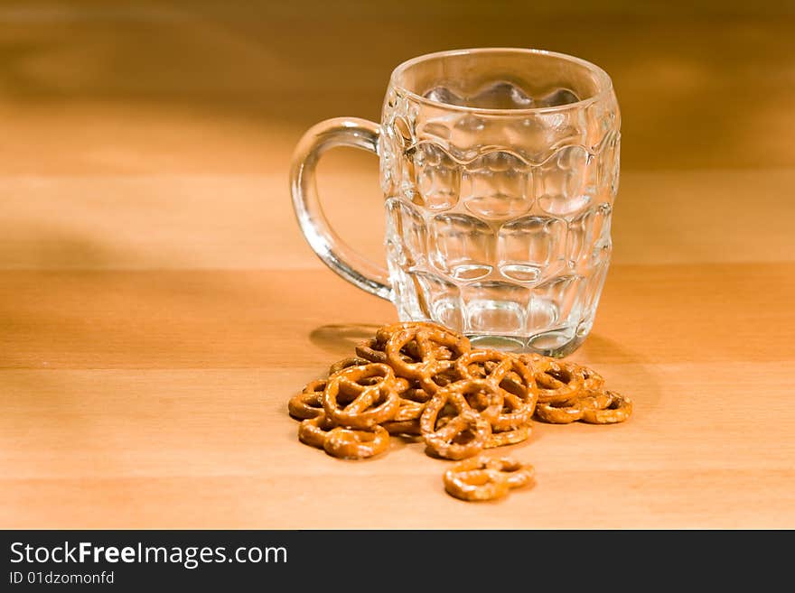 Empty beer glass with salty snacks. Empty beer glass with salty snacks