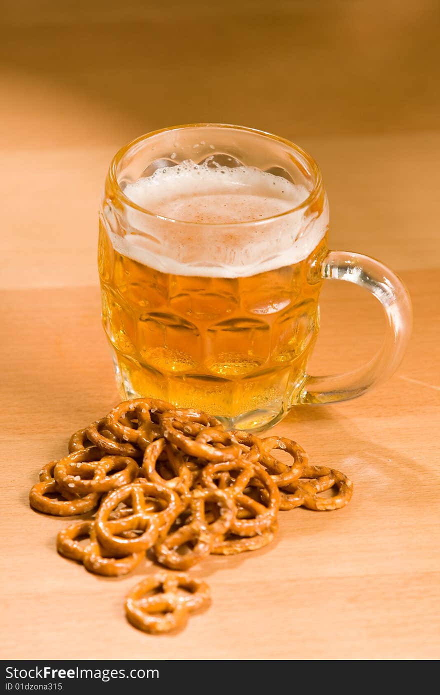 Glass of beer with salty snacs