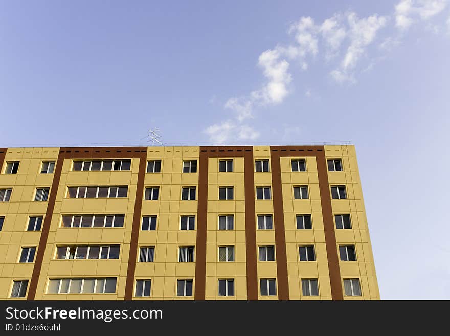 A background of a modern building in yellow and brown color, with furnishings of aluminum for windows. A background of a modern building in yellow and brown color, with furnishings of aluminum for windows.