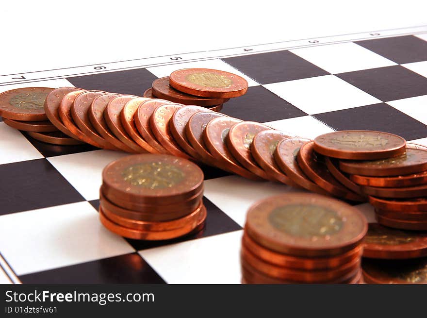 Columns of  coins on the chessboard isolated on the white background. Columns of  coins on the chessboard isolated on the white background.