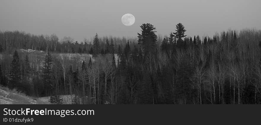 Full Moon Over Forested Hills