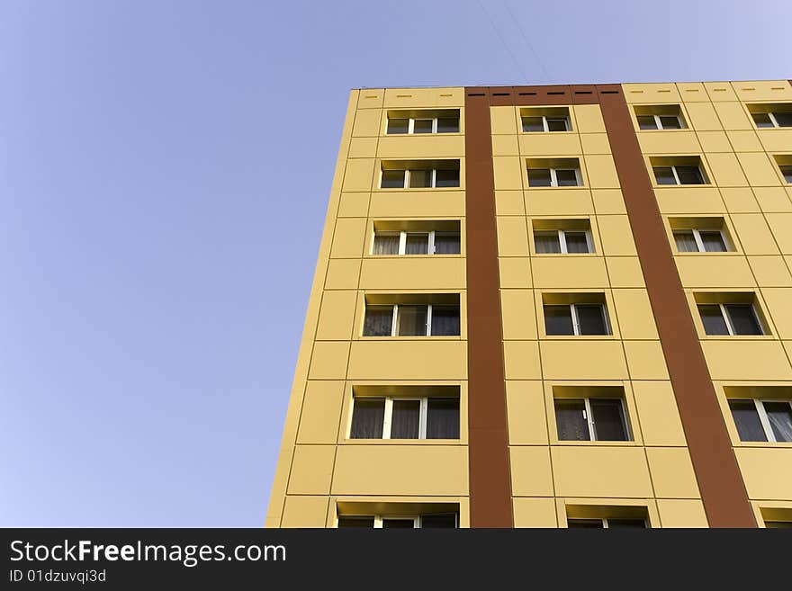 A background of a modern building in yellow and brown color, with furnishings of aluminum for windows. A background of a modern building in yellow and brown color, with furnishings of aluminum for windows.