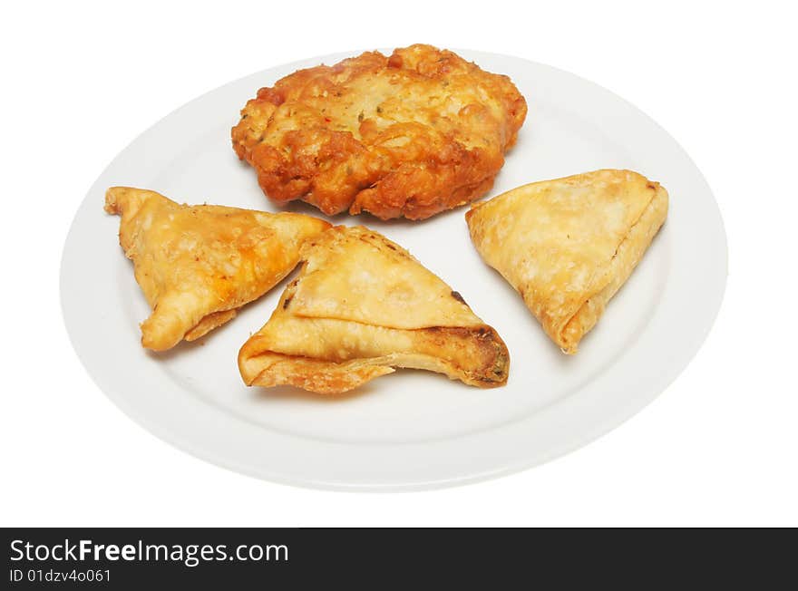 Samosa and onion bhajji on a plate. Samosa and onion bhajji on a plate