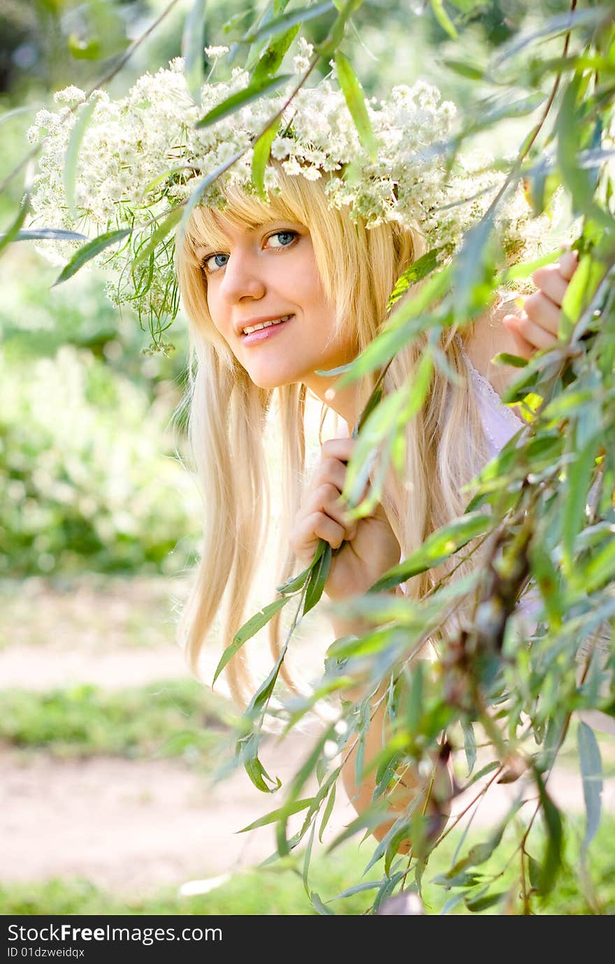 Girl the blonde looks out because of foliage. Girl the blonde looks out because of foliage