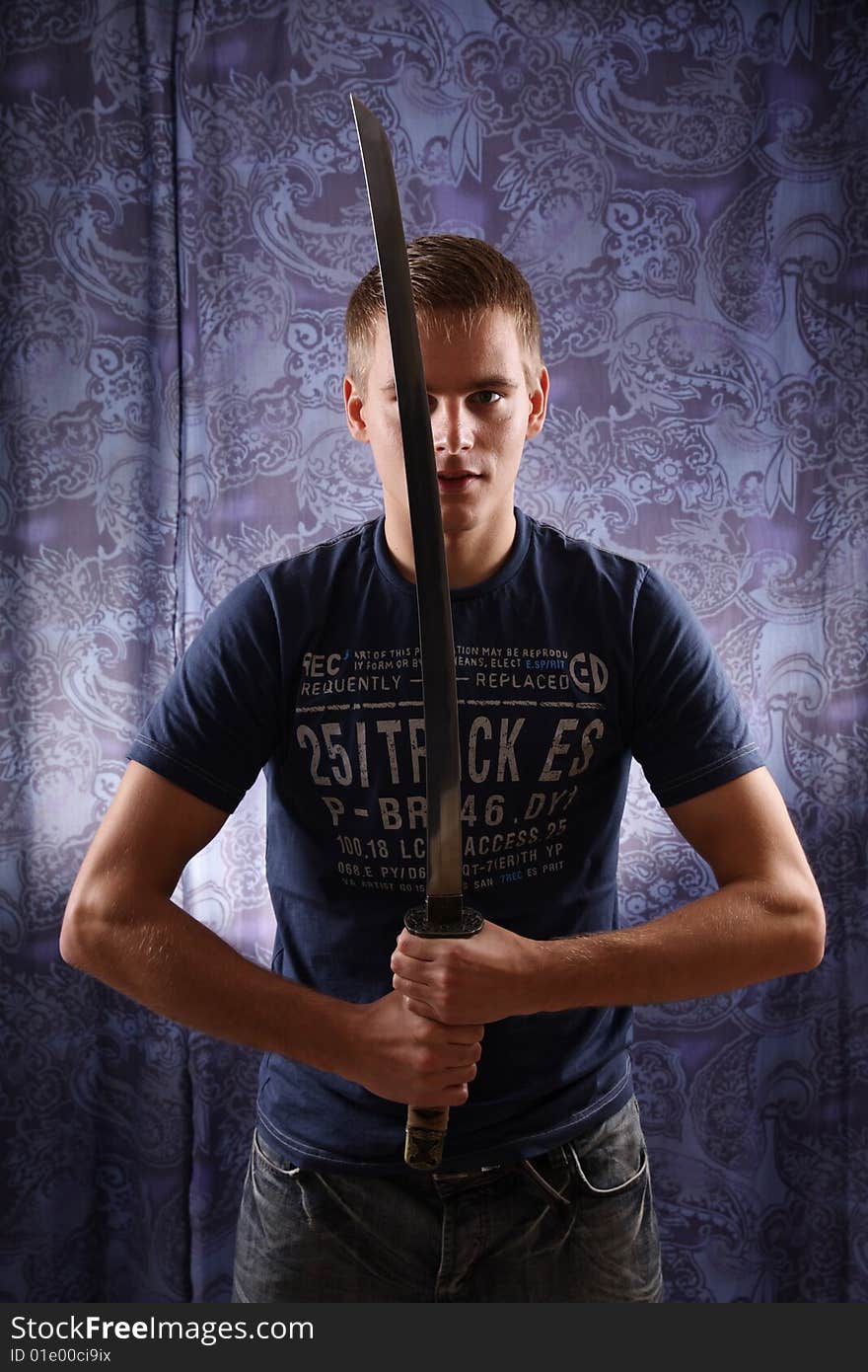 Studio portrait of young man and katana