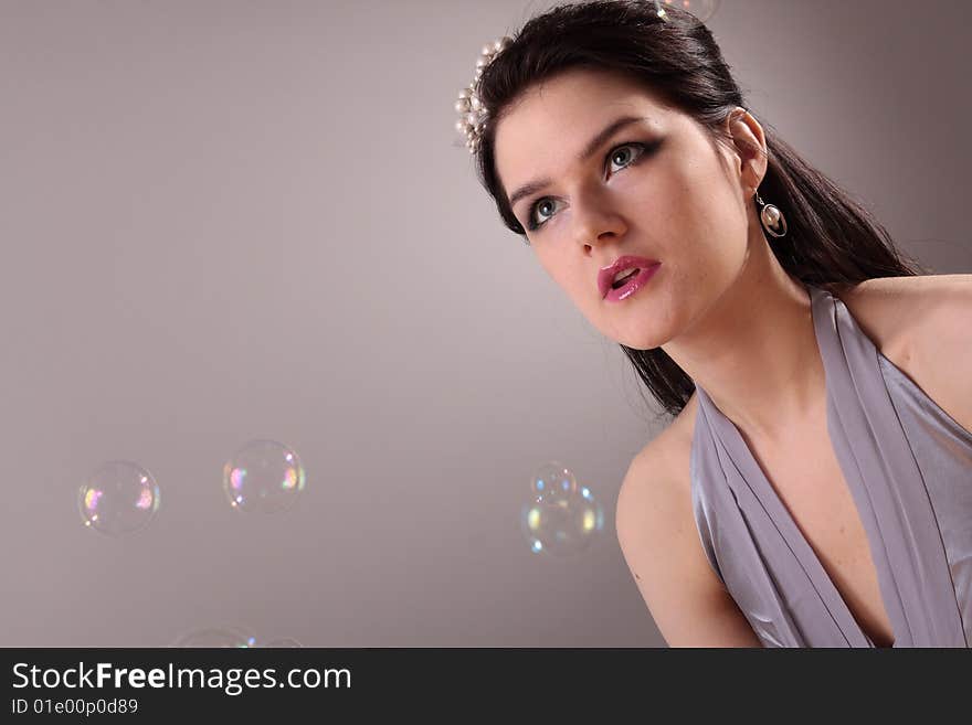 Beautiful fashion model in studio and soap bubbles