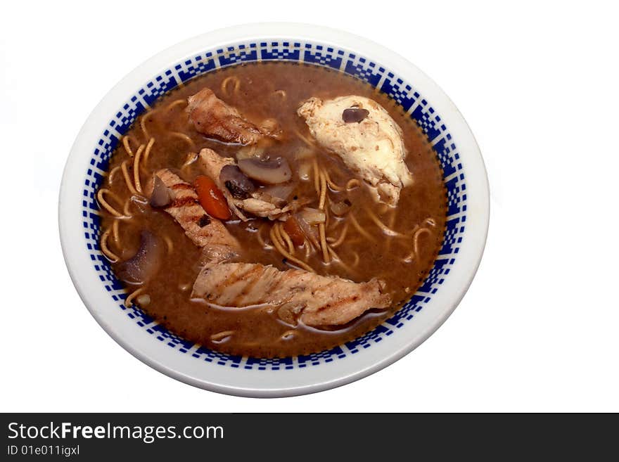 Bowl of delicious Chicken Ramen. Made with Grilled chicken, mushrooms, egg noodles onions, vegetables and Miso sause