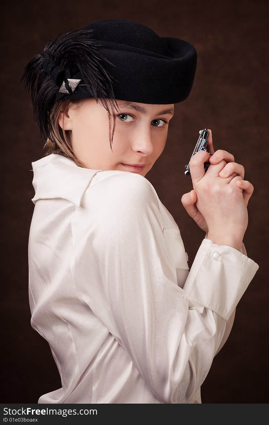 Young girl holding a pistol in hands