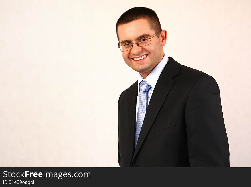 Young businessman on isolated background smiling