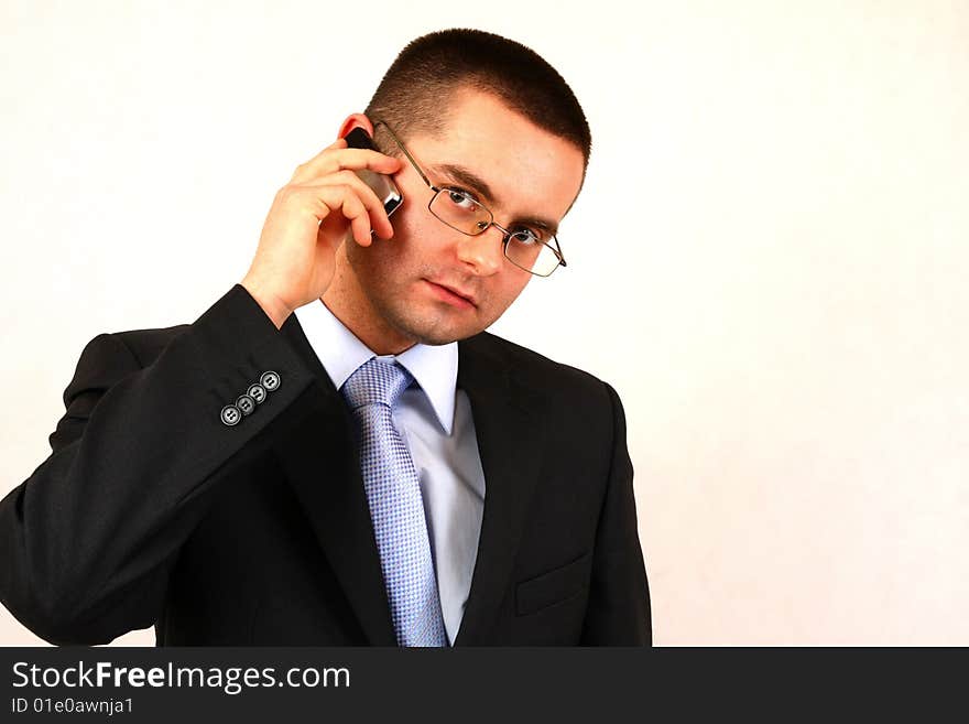 Young businessman on isolated background with a cell phone. Young businessman on isolated background with a cell phone