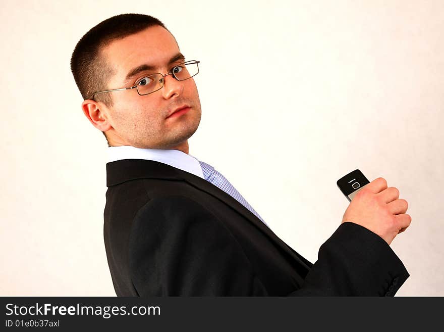 Young businessman on isolated background with a cell phone. Young businessman on isolated background with a cell phone