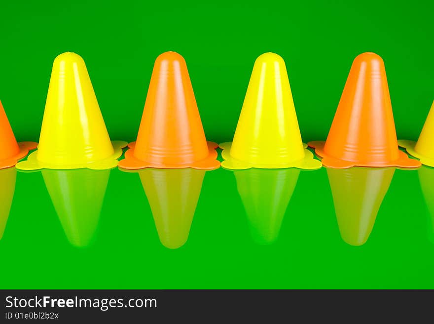 Witches hats isolated against a green background