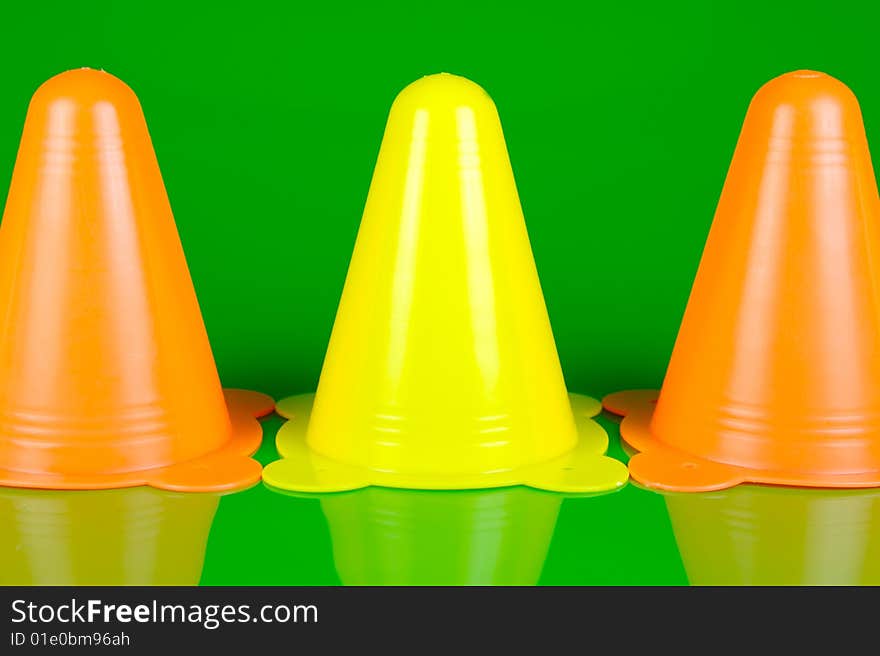 Witches hats isolated against a green background