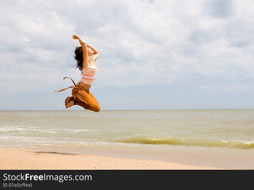 Happy Woman Is Jumping In Beach