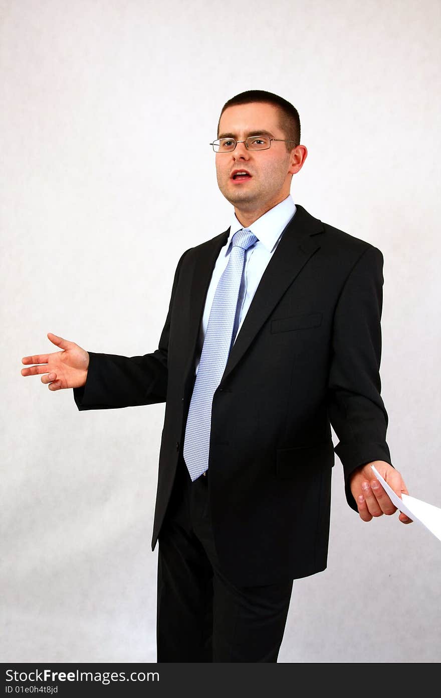 Young businessman on isolated background with a piece of paper. Young businessman on isolated background with a piece of paper