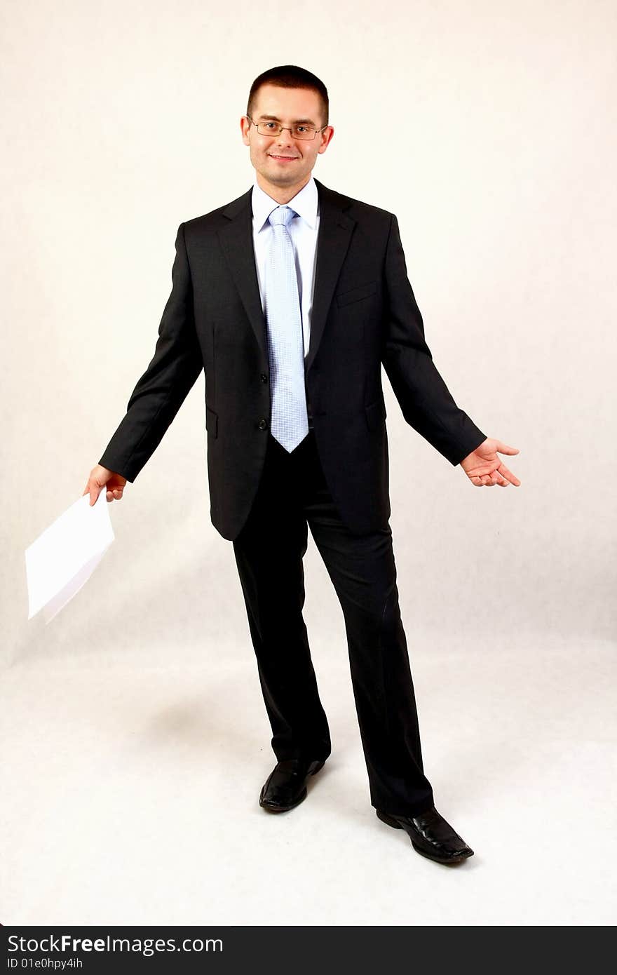 Young businessman on isolated background with a piece of paper. Young businessman on isolated background with a piece of paper