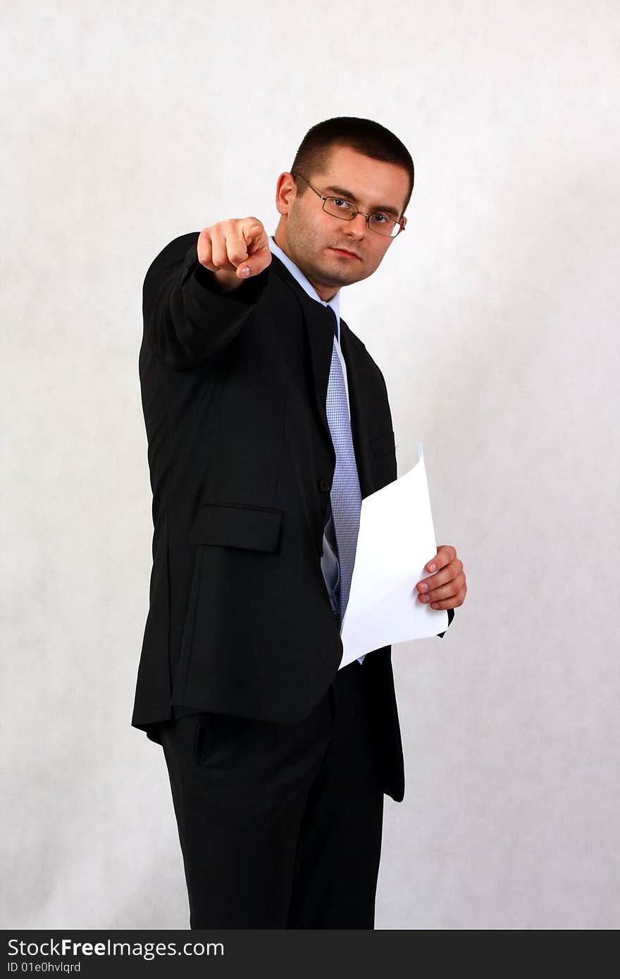 Young businessman on isolated background pointing with his finger