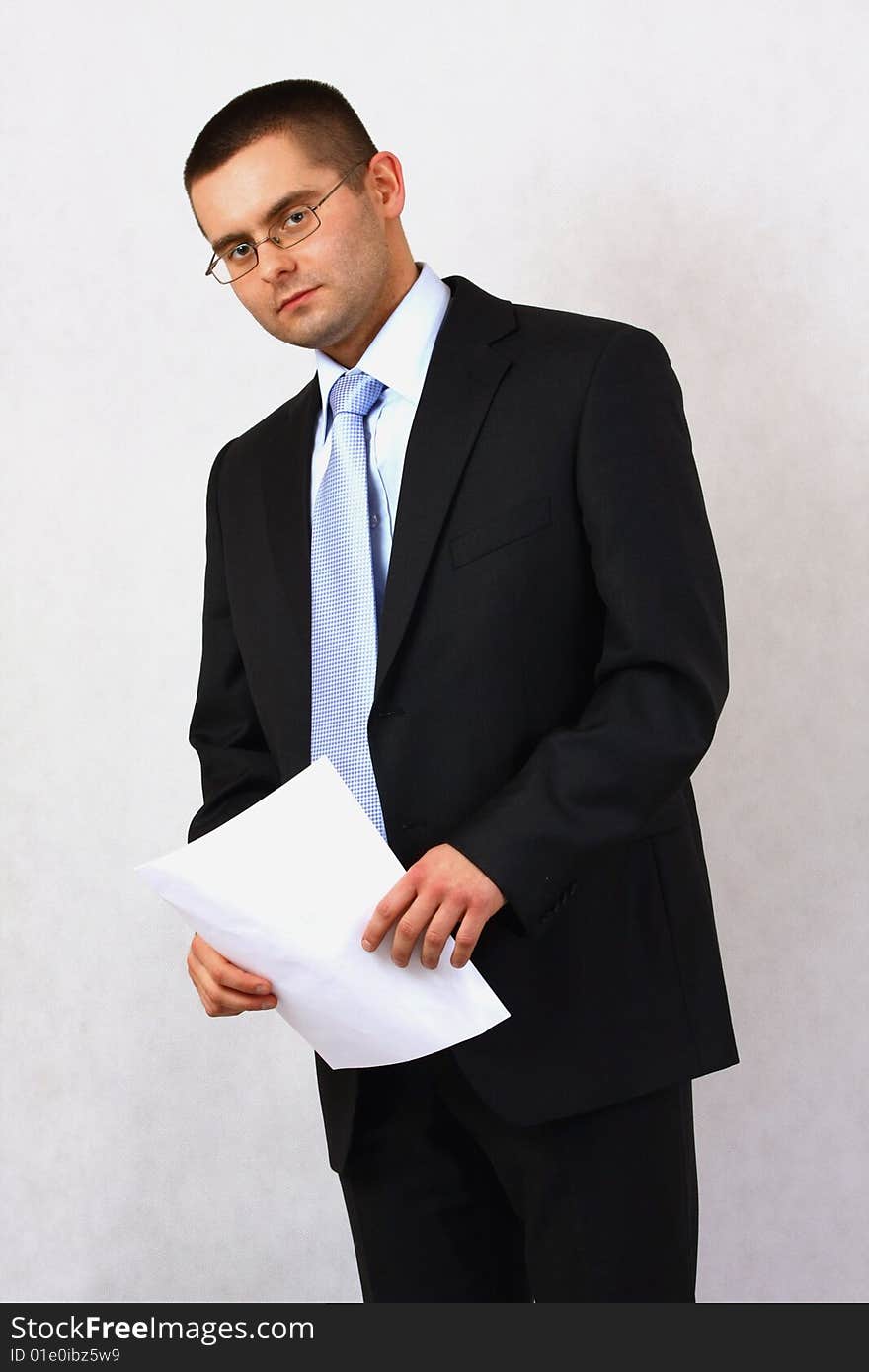 Young businessman on isolated background with a piece of paper. Young businessman on isolated background with a piece of paper