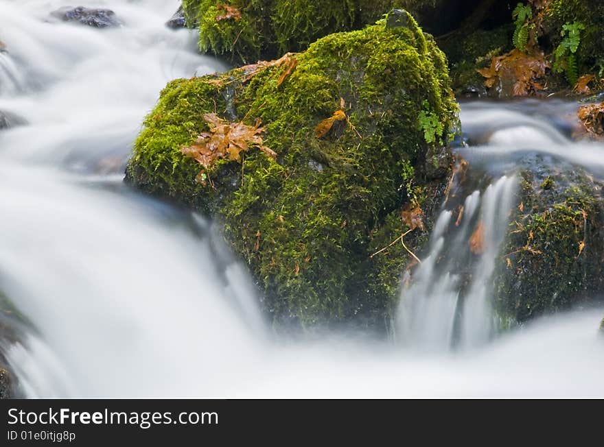 Water flowing down a creek closeup.