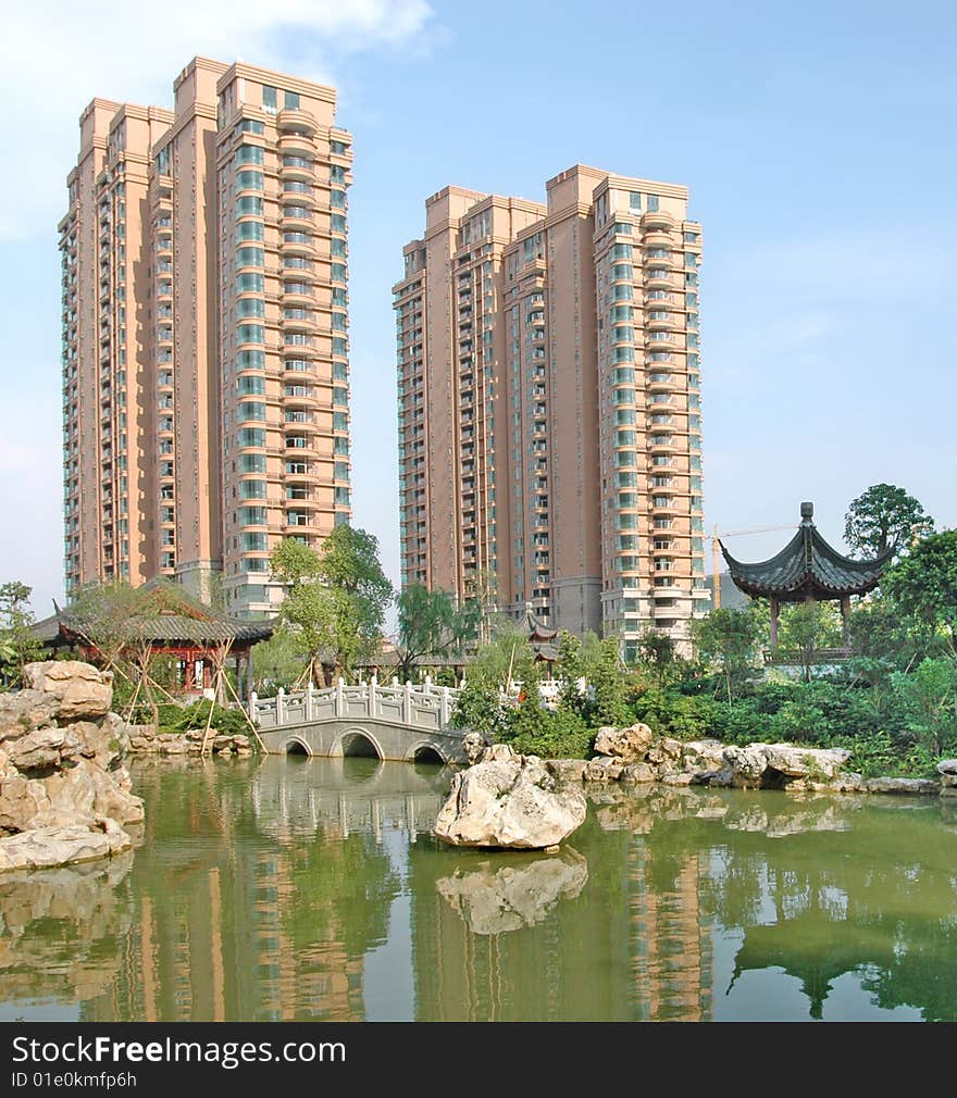 There are two upscale apartment block by the lakeside,beautiful reflection in the calm lake water suface.