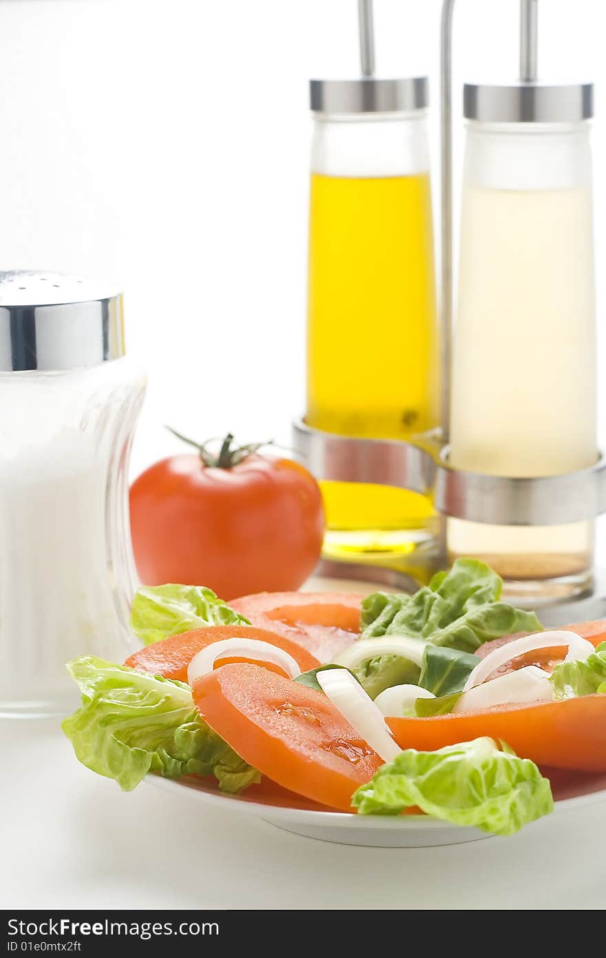 Fresh natural salad bowl tomato lettuce onion oil vinegar