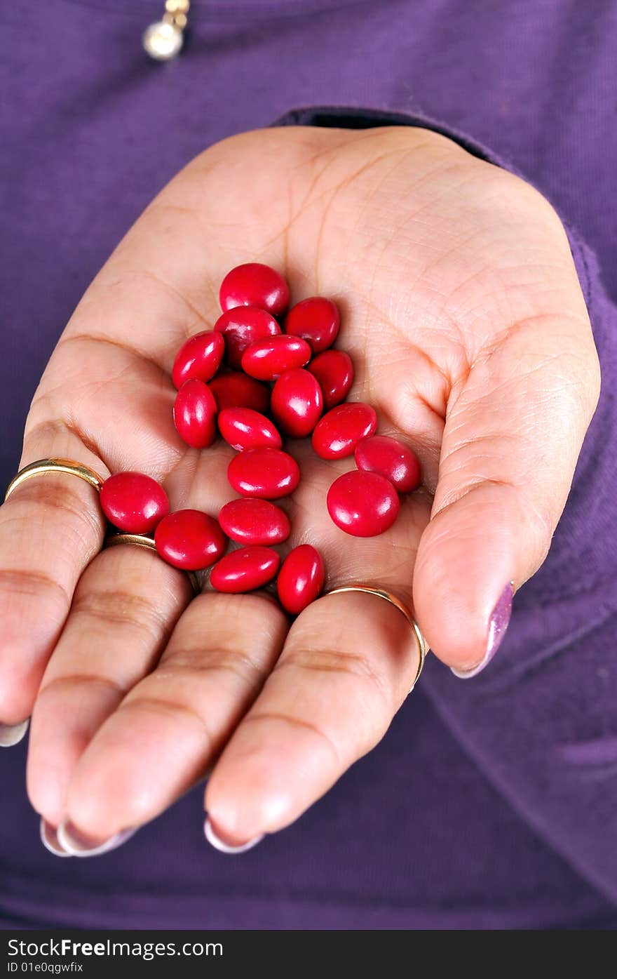 Female hand with red pills. Female hand with red pills.