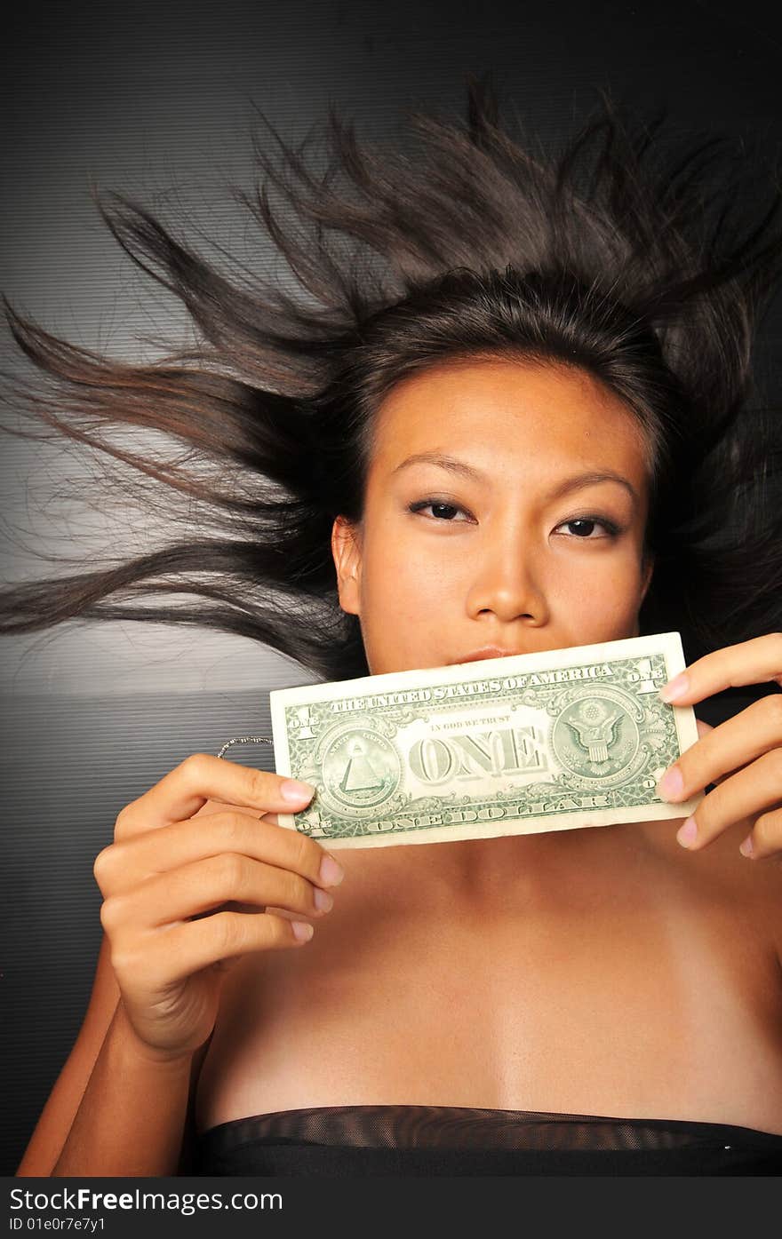 Asian chinese woman holding a dollar bill