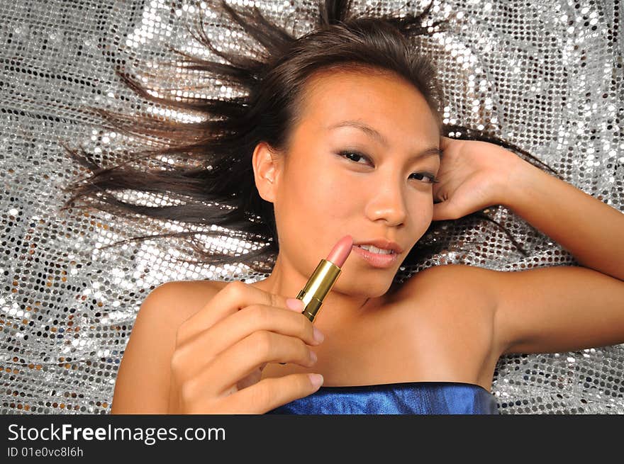 Asian chinese woman with her lipstick