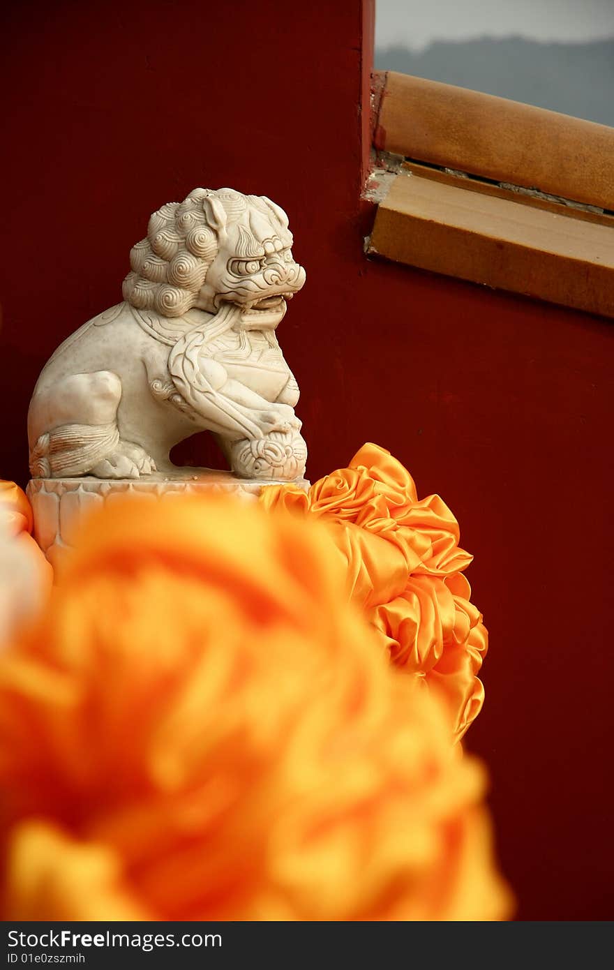 Stone lion by the red wall of Badachu Temple ,Beijing ,China