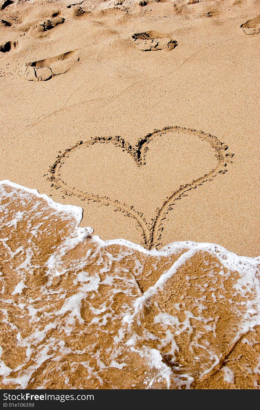 A heart sign in the sand on a beach. A heart sign in the sand on a beach