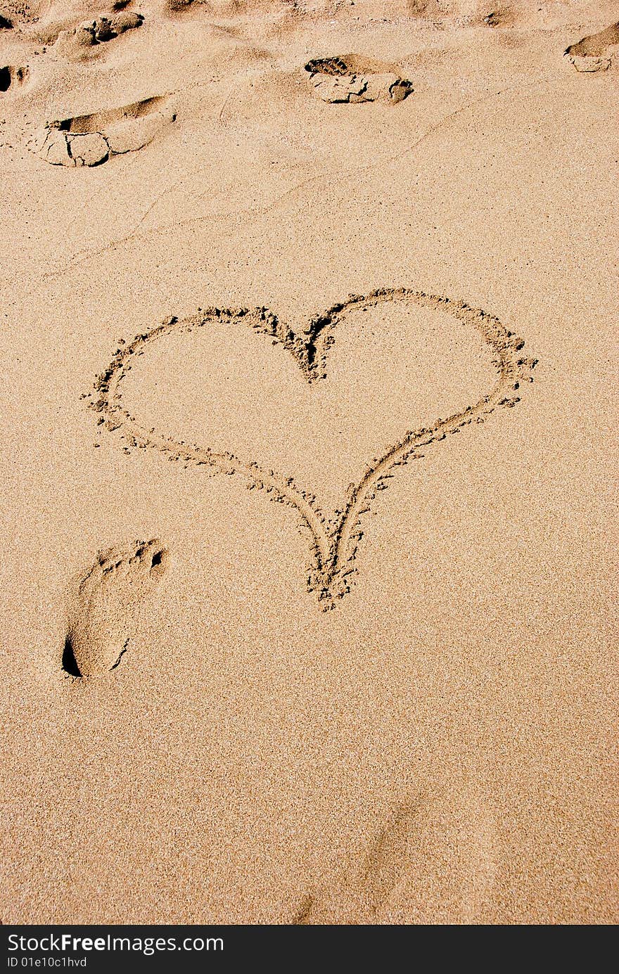 A heart sign in the sand on a beach. A heart sign in the sand on a beach