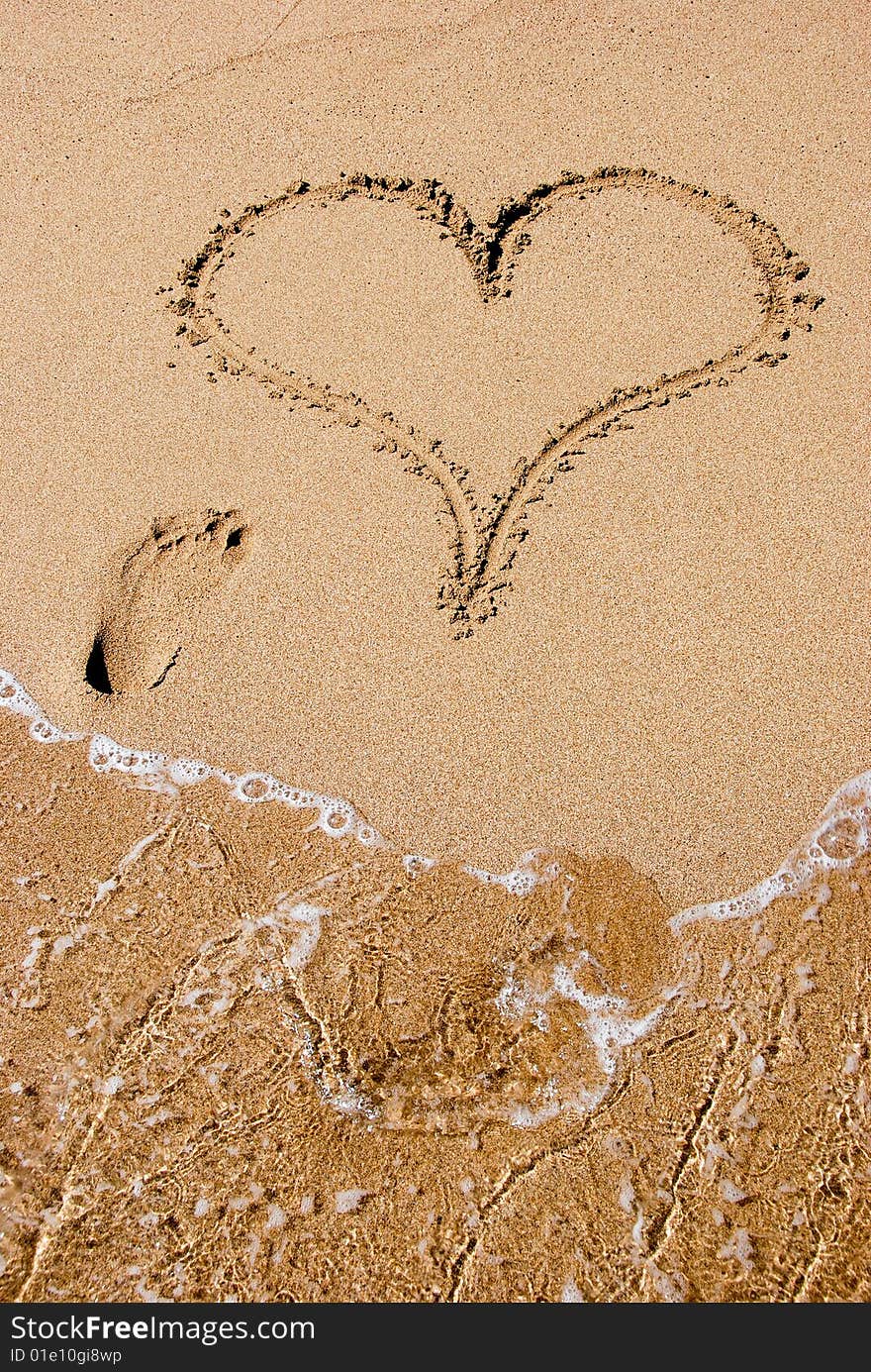 A heart sign in the sand on a beach. A heart sign in the sand on a beach