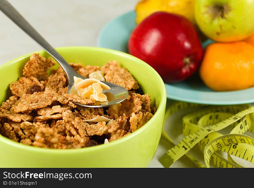 Cereal flakes and dried fruits in a green bowl. Cereal flakes and dried fruits in a green bowl