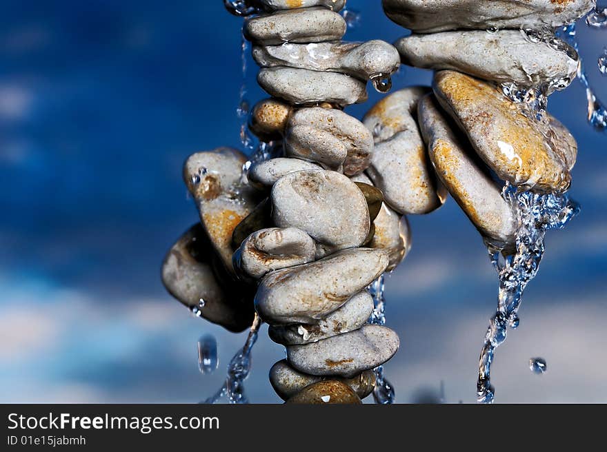 Water on a pile of sea stones in the evening. Water on a pile of sea stones in the evening