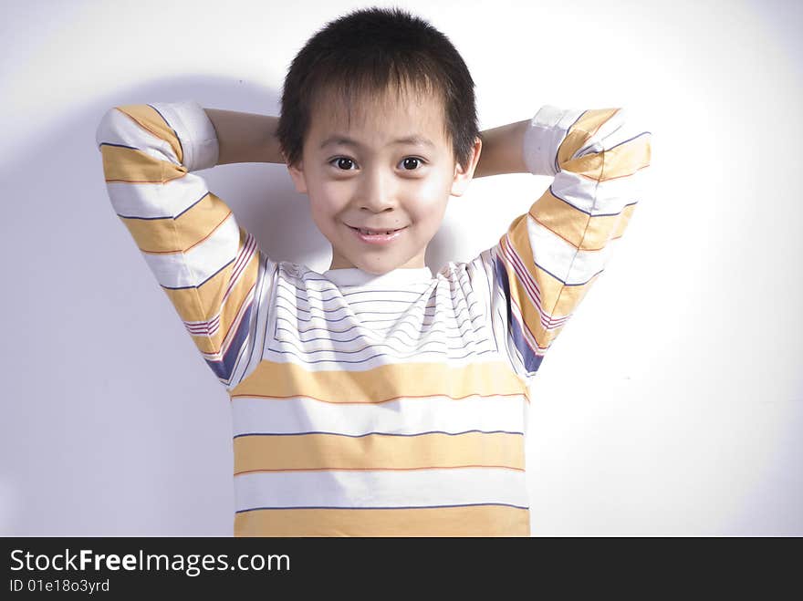 A Boy puts this hands back of head