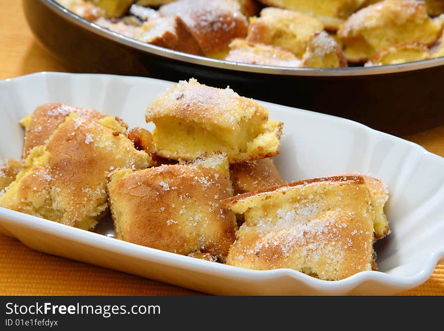 Baked dough with powdered sugar on plate