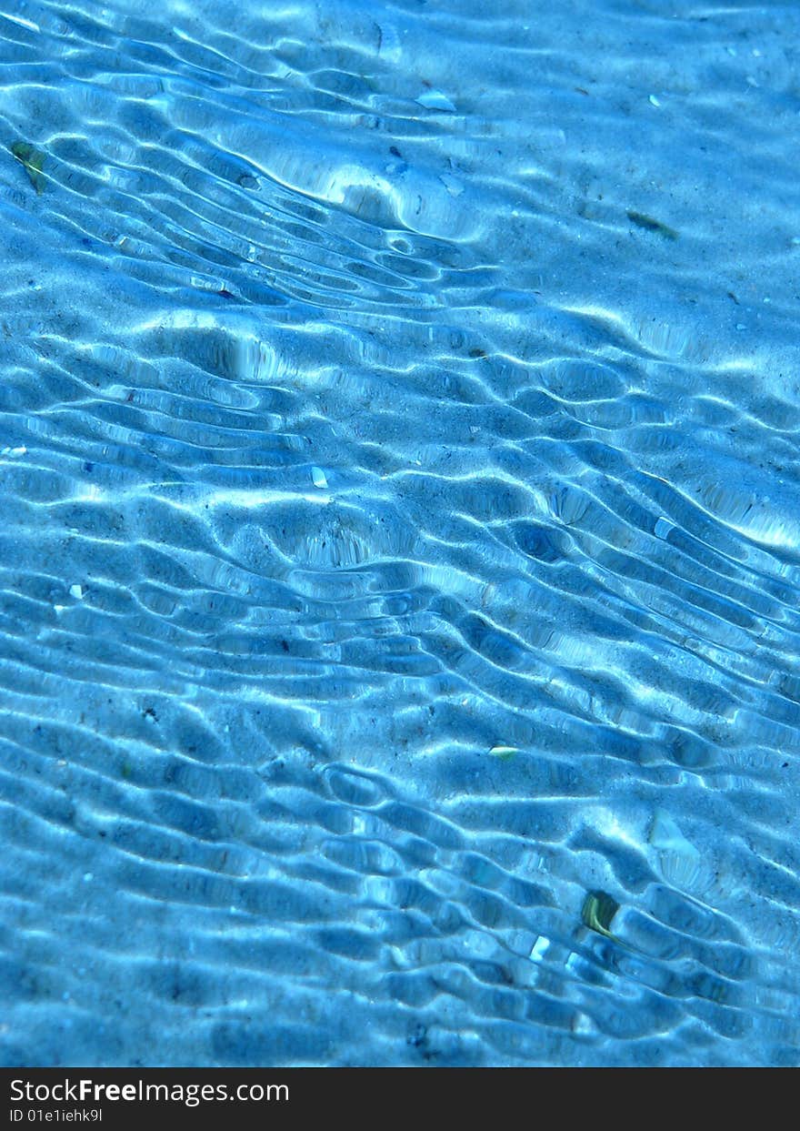 Sunbeams in azure, sea water running on bottom. Sunbeams in azure, sea water running on bottom