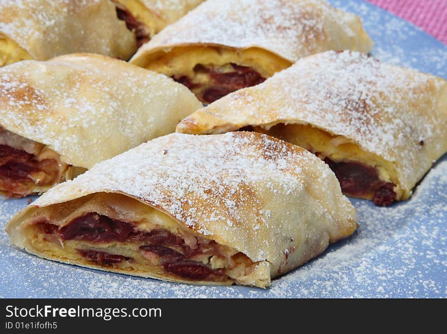 Sour cherry pie with sugar on plate