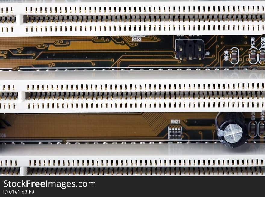 Close-up of section of a computer motherboard showing rows of PCI slots. These are used for expansion cards, such as graphics, sound and accelerator cards for data input and output. No trademarks / logos.