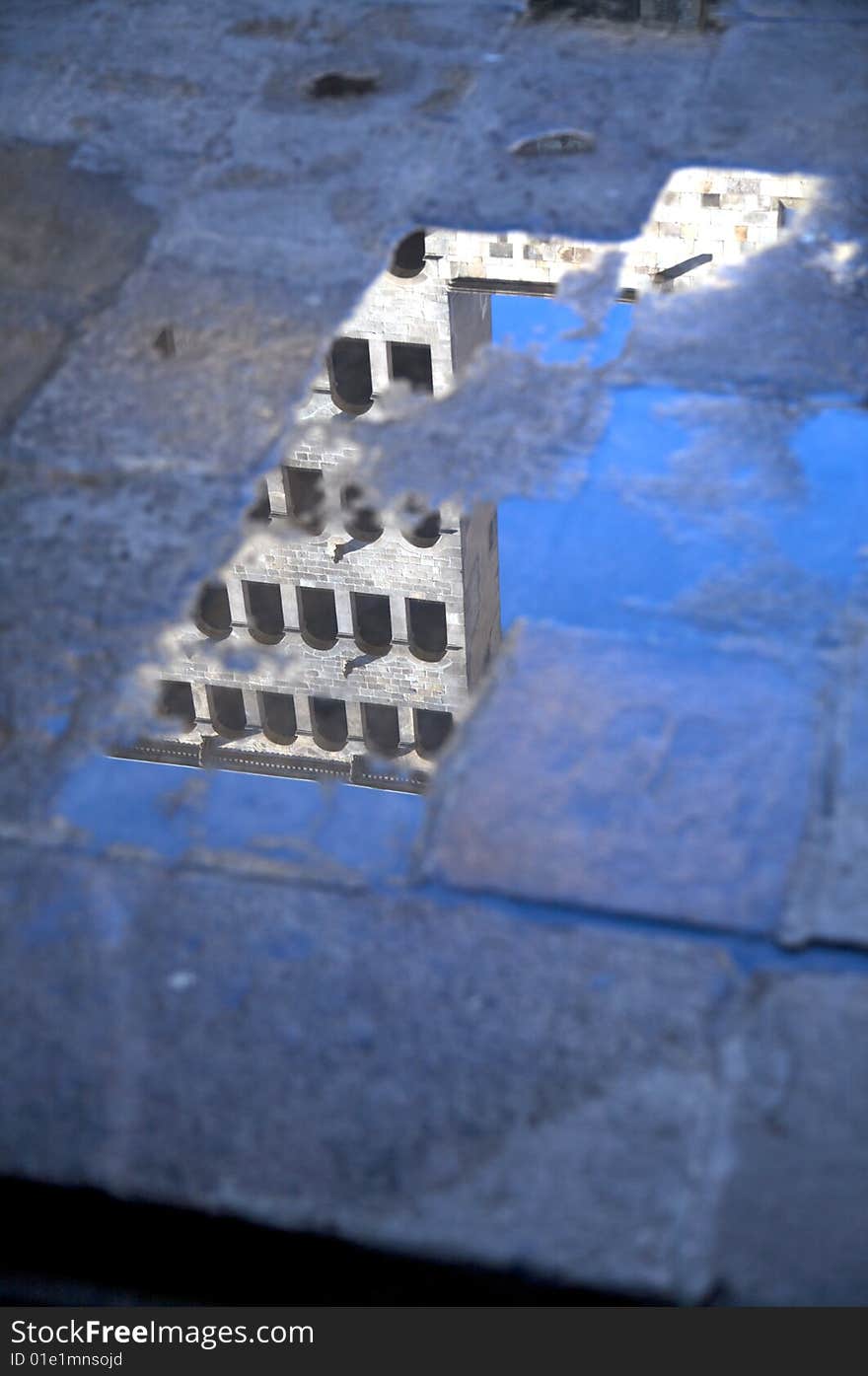 Building with windows reflected on a puddle in barcelona. Building with windows reflected on a puddle in barcelona